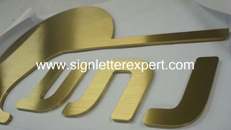 Golden brushed stainless steel letter signage