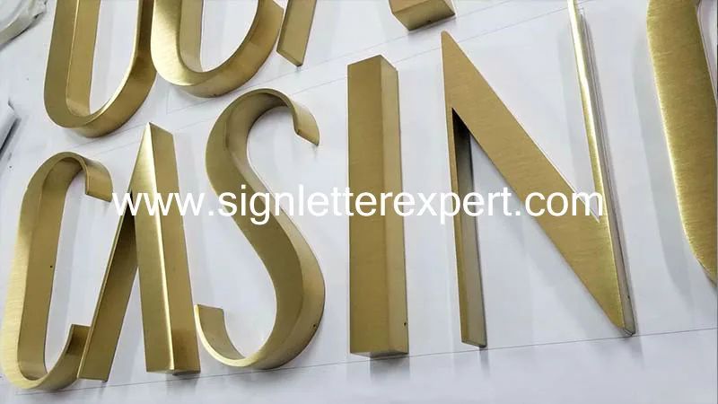 Golden brushed stainless steel letter signage