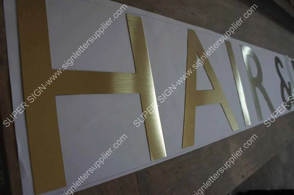 golden brushed steel lettering — additional workshop photograph of the finished letter