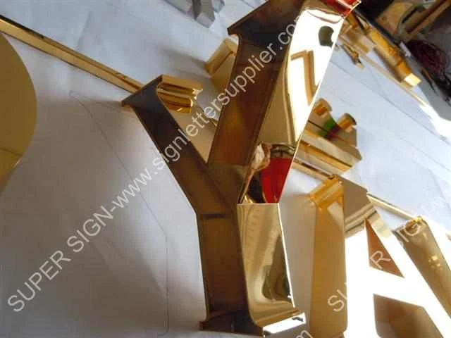 golden polished steel letter 03 — additional workshop photograph of the finished letter