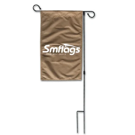 Row of garden flags in different sizes and designs displayed on flag poles in a garden