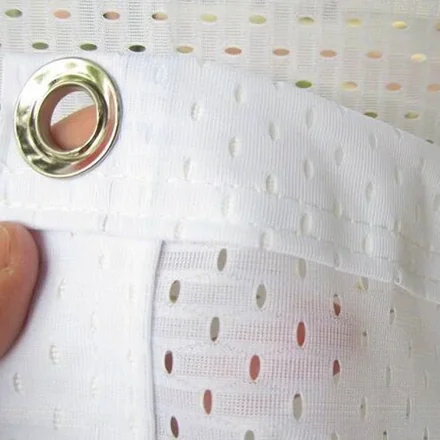 Custom-sized mesh banner being measured for a unique outdoor setup