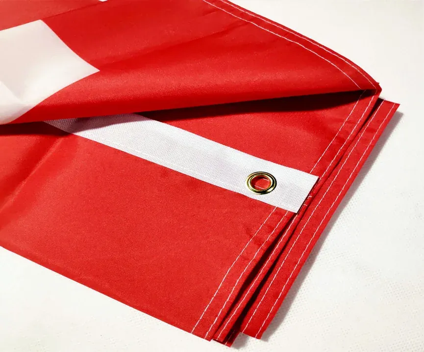 A finished banner hem with a reinforced grommet.
