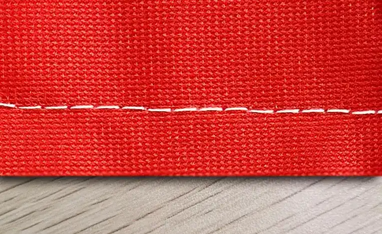 Double-stitched hem on printed polyester.