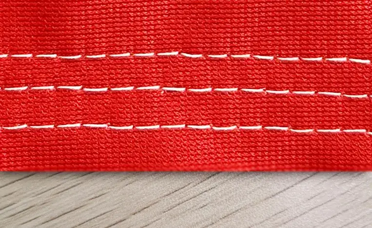 Reinforced edge stitching across the full width of a banner.