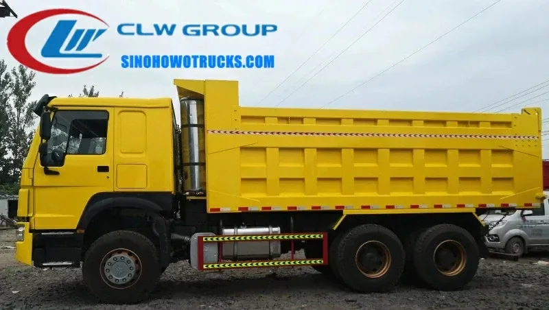 10 wheel Sinotruk HOWO 25cube tipper truck in action at a quarry site in Zambia with front lift hydraulic system raised