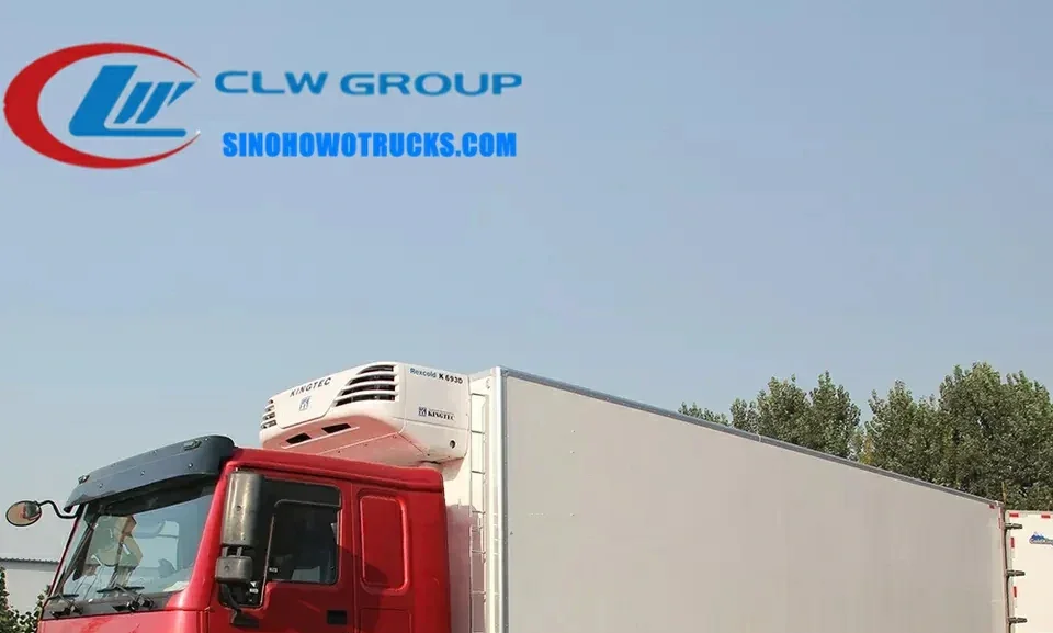 12 wheel Sinotruk HOWO 40ft chiller van truck in white with rear door open and PVC strip curtain visible