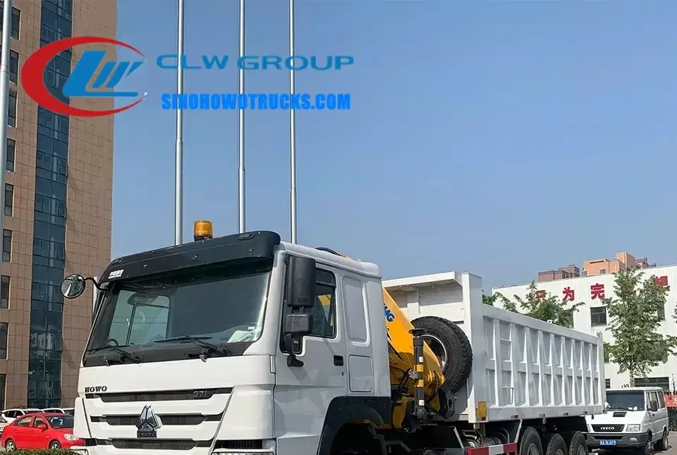 14 wheeler Sinotruk HOWO 20 ton tipper dump truck with crane in construction site environment