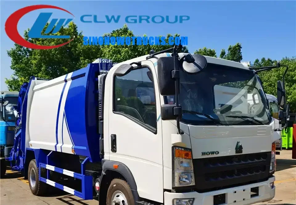 RHD HOWO 8m3 waste compactor truck in urban setting with rear loading system engaged