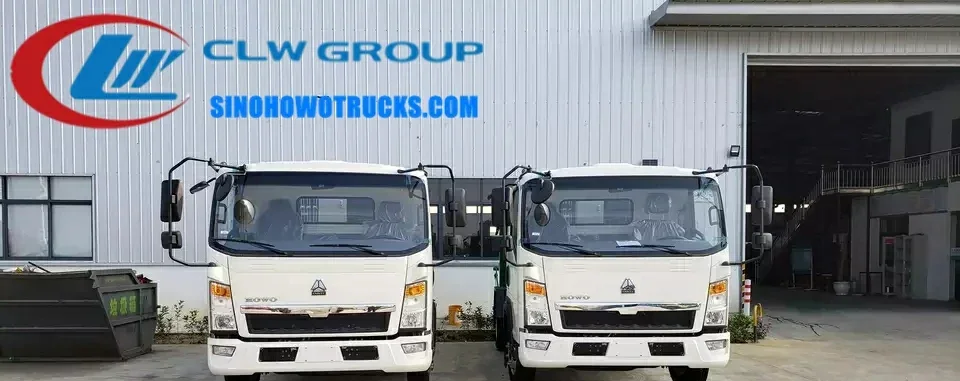 Right hand drive Sinotruk rubbish lorry in urban waste collection setting with compaction body open