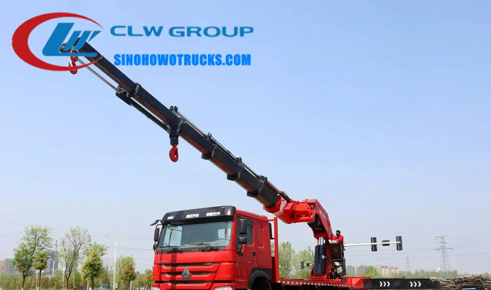 Sinotruk HOWO 110 ton construction crane truck in Sierra Leone with telescopic boom extended and crane operator in cab