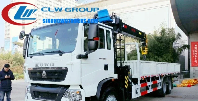 Sinotruk HOWO 12 ton crane truck with telescopic boom in operation on a construction site
