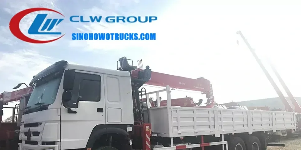 Sinotruk HOWO 6x4 truck mounted crane with Palfinger crane in action at a construction site