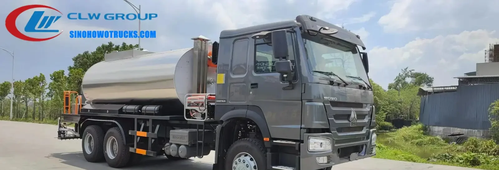 Sinotruk HOWO 14m3 asphalt patch truck in service on a road construction site with spray system active