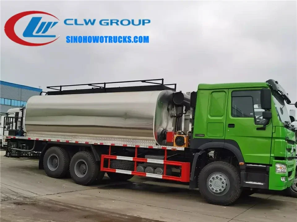 Sinotruk HOWO 6x4 asphalt distributor sprayer in road construction setting with spray system active