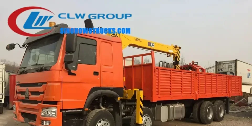 Sinotruk HOWO 18 ton telescopic truck mounted crane with grabber in operation at a construction site