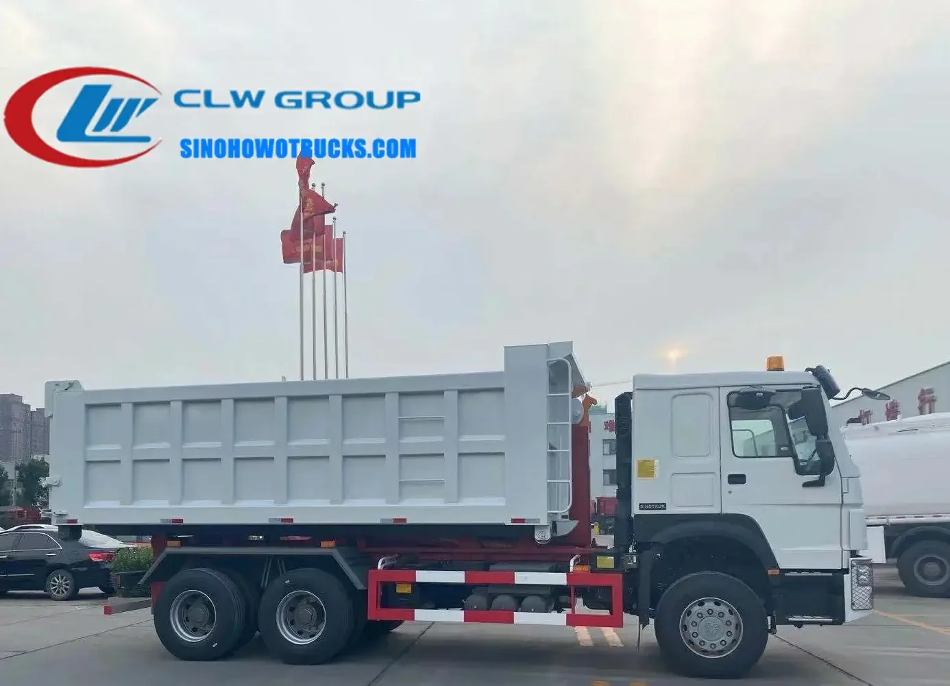 Sinotruk HOWO 18 ton roll off dumpster truck in service with hydraulic hook loader lifting a 22 cubic meter container
