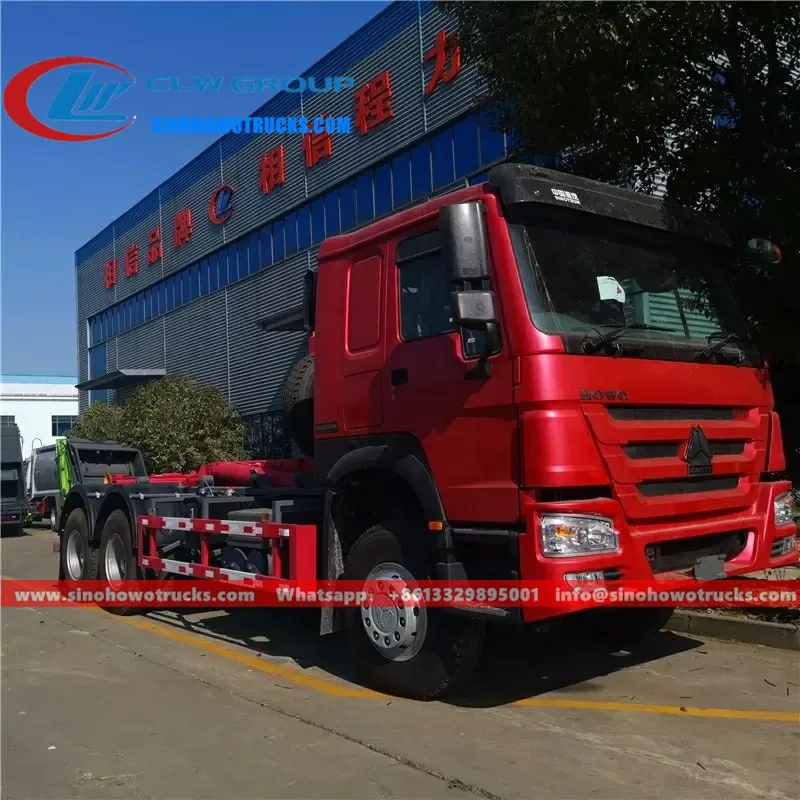 Sinotruk HOWO 20 ton roll on roll off truck in metallic grey with hook loader system lifting a waste container