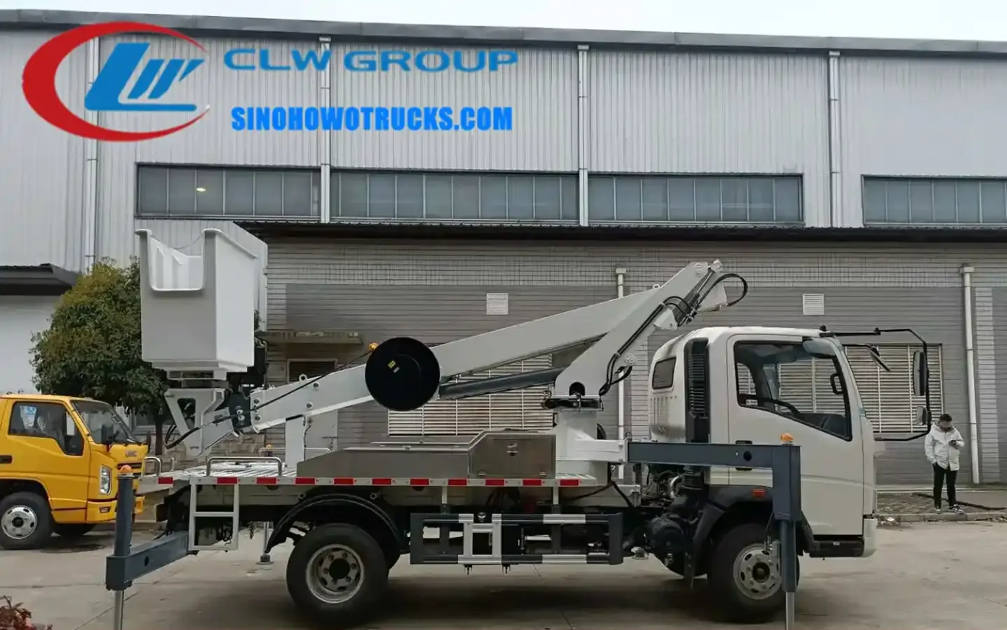 Sinotruk HOWO 23 meter man lift boom truck in urban setting with extended telescopic boom and working cage
