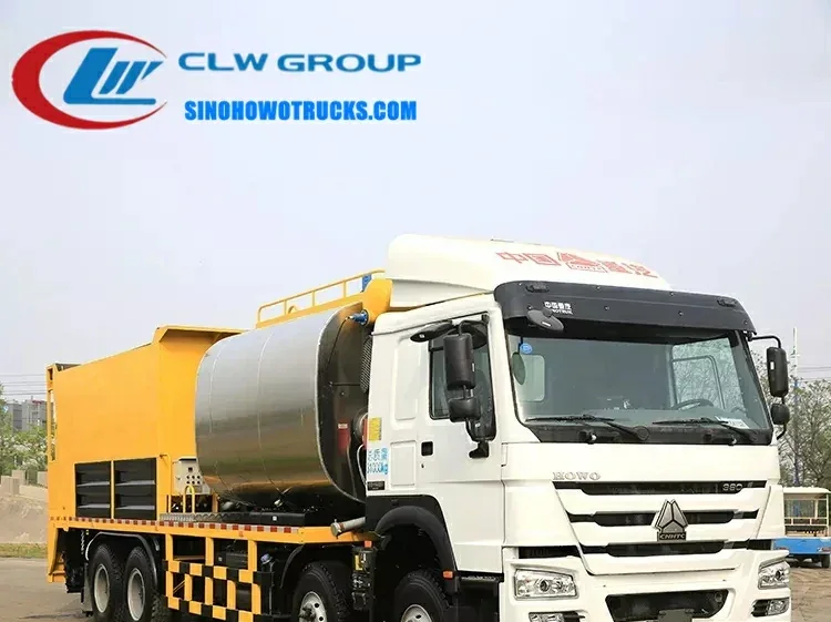 Sinotruk HOWO 24m3 asphalt spreader and distributor truck in operation with asphalt spray and gravel spreading