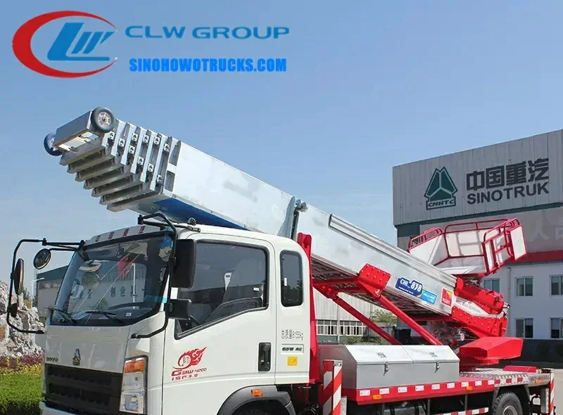 Sinotruk HOWO 45m aerial ladder truck in urban setting with hydraulic boom raised and platform at full height