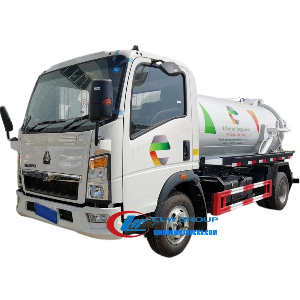 Sinotruk HOWO 5 ton sewage removal truck in urban environment with suction hose connected to a manhole