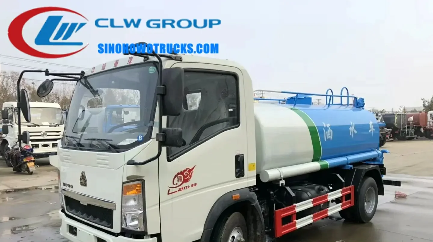 Sinotruk HOWO 4x2 mini water tanker truck with 5000 L tank and rear spray nozzles in urban setting