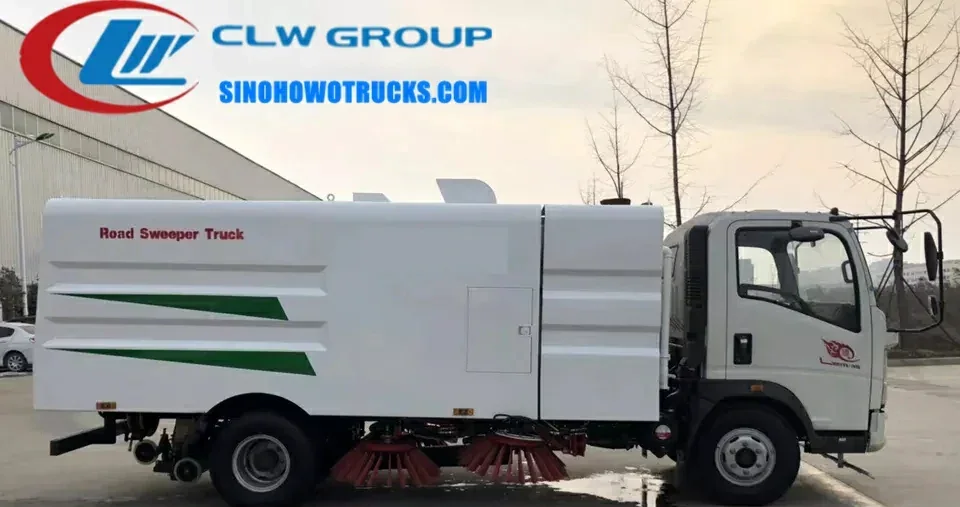 Sinotruk HOWO 4x2 road sweeper truck in urban environment with front brushes and suction nozzle in operation