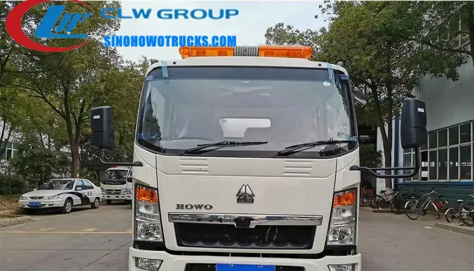 Sinotruk HOWO 6 ton jet vac truck with 5 cbm tank in service in Vietnam, rear view showing hydraulic lift and suction pipe