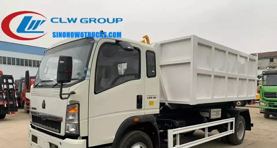 Sinotruk HOWO 8 ton hook arm roll off garbage truck in green and white with 6 CBM container mounted on the rear
