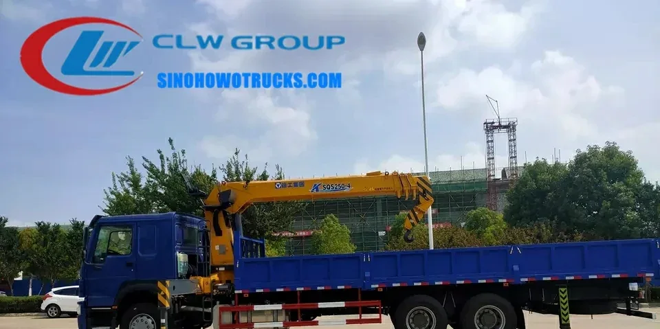 Sinotruk HOWO 6x4 heavy duty truck crane with telescopic boom in operation on a construction site