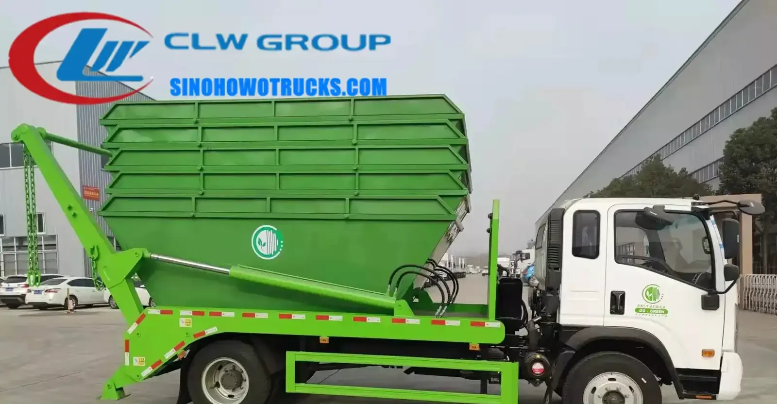 Sinotruk mini skip loader truck in urban waste collection setting with swing arm lifting a 8cbm skip container