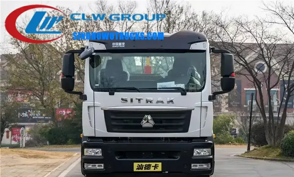 SINOTRUK SITRAK single axle roll off truck in urban waste collection setting with container being lifted