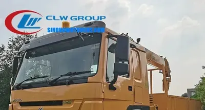 Side view of the HOWO crane truck showing the 6x4 chassis and cargo body