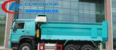 10 wheeler Sinotruk HOWO 30 ton mining haul truck in action at a quarry site with ventral lifting tipper