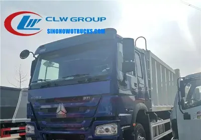 12 wheeler Sinotruk 16cbm rear loader garbage truck in urban waste collection setting with rear container lift engaged