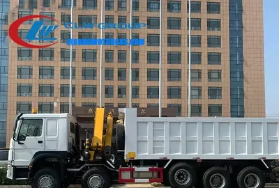 Side view of the truck-mounted crane with telescopic boom extended and lifting load