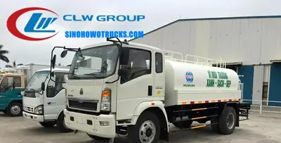 4×2 Sinotruk HOWO water truck with 10000 L tank in service blue, front nozzle and rear sprinkler visible