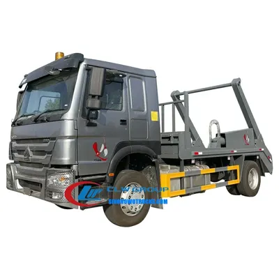 Rear view of the skip loader truck with the bin being dumped at a landfill site
