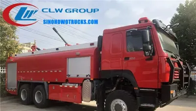 Aluminium alloy roller shutter lockers open on the side of the HOWO fire tender with hoses and equipment visible