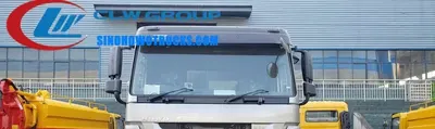 6x4 Sinotruk HOWO 18m3 garbage compactor truck in urban waste collection setting with hydraulic compaction system in operation