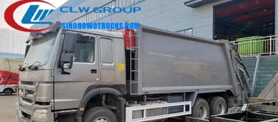 Side view of the 6x4 HOWO compactor truck showing the 20m3 hermetic waste body and container lifting mechanism