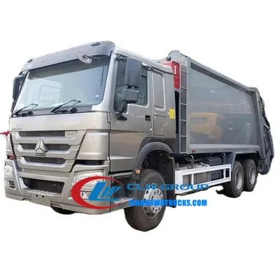 Rear view of the 6x4 HOWO garbage truck with hydraulic unloading system and sewage tank access door