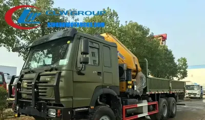 Side view of the 6×6 HOWO crane truck showing the cab, crane boom, and high ground clearance