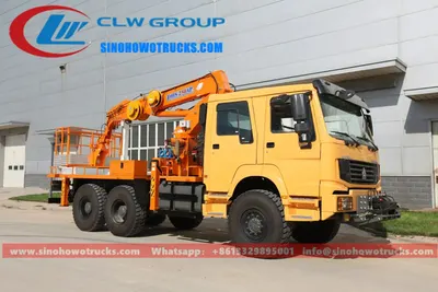 Side view of the 6x6 HOWO aerial lift truck showing outriggers deployed and working cage on the boom