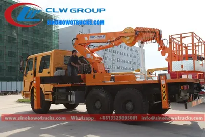 Rear view of the 6x6 HOWO manlift truck with hydraulic boom and control panel visible