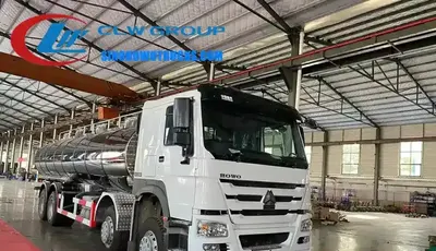 8x4 Sinotruk HOWO 25000 litre dairy tanker truck in white with stainless steel tank and rear water cannon