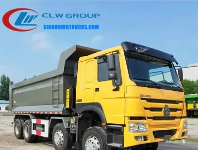 Front view of the HOWO dump truck showing the cab, grille, and front-lift hydraulic system