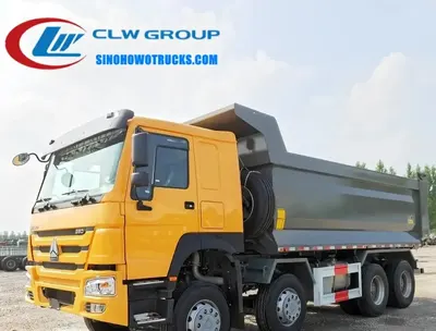 Side view of the HOWO gravel truck with open tipper body and hydraulic pistons visible