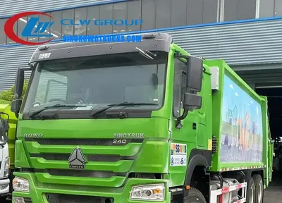 CNHTC HOWO 20cbm compactor dustbin truck in urban waste collection service with rear loading mechanism in use